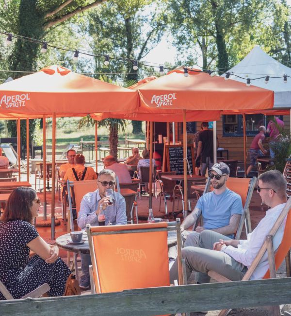 Group of people sitting on the terrace at the beach restaurant in Vogelgrun